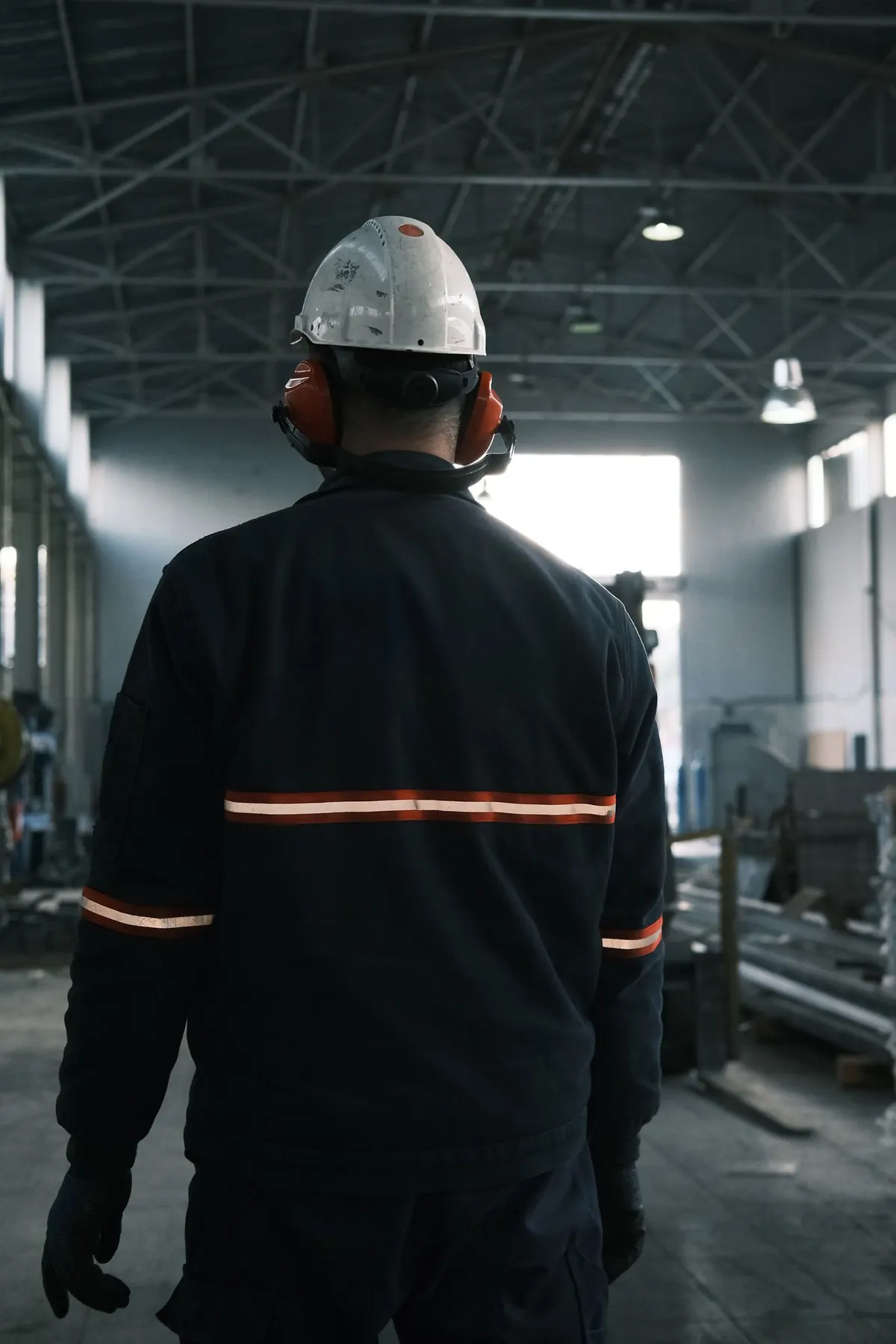 Worker in full safety equipment inside an industrial plant